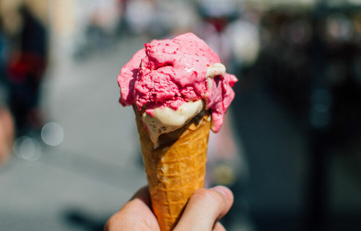 55 ways to save money - view of hand holding ice cream cone