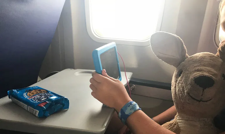 flying with kids take a tablet
