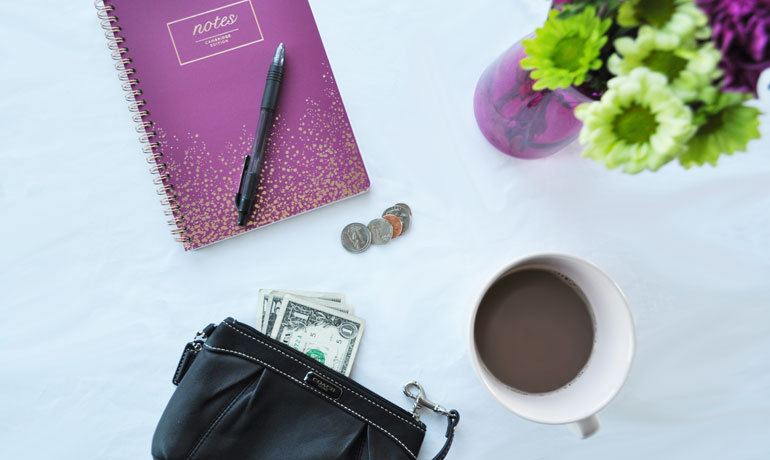 Emergency fund basics view of money notebook coffee flowers 