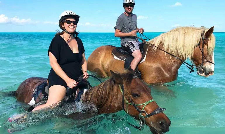 turks and caicos excursions horseback riding travel couple on horses in ocean