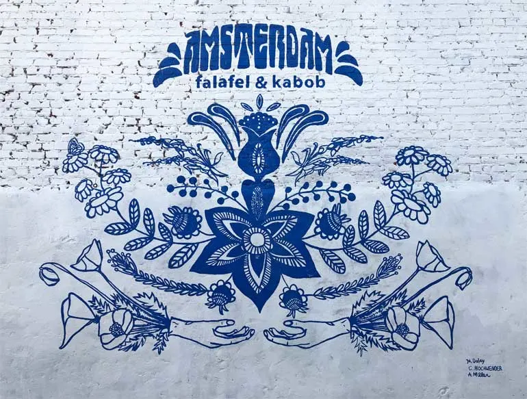 mural in Omaha at Amsterdam falafel and kabob blue and white with flowers