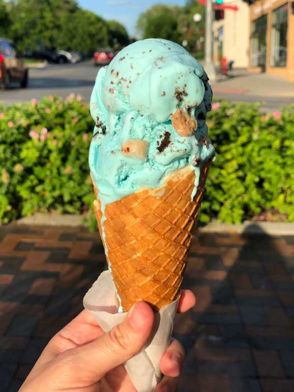 blue cookie monster ice cream with blurry background on a hot summer day