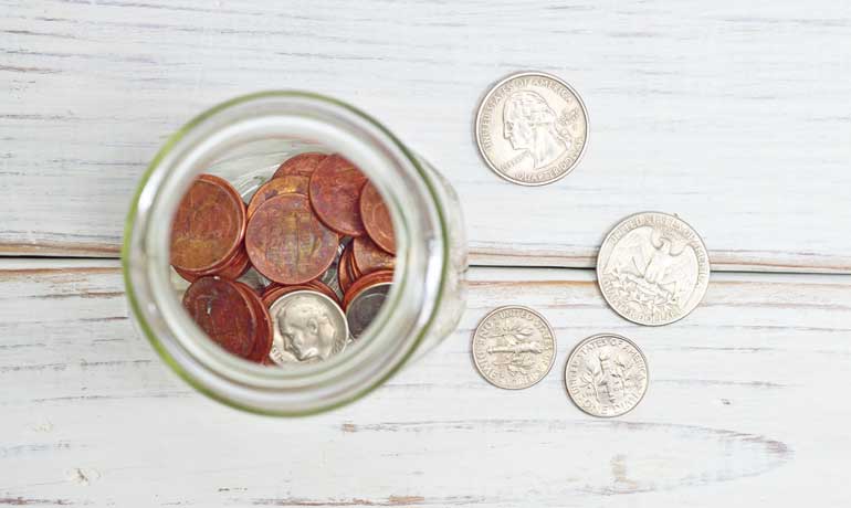 money stress money on jar and board looking down