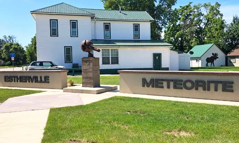 estherville meteorite sign with house in background