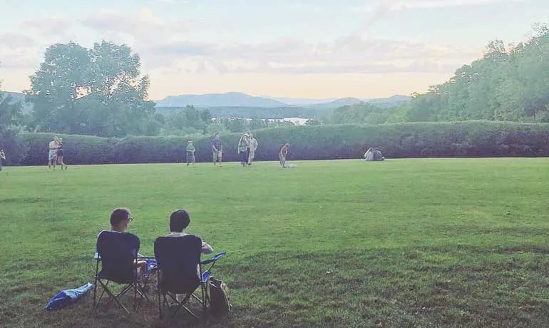 the berkshires - view looking out over field and sunset in background