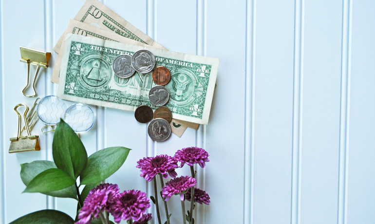 cash on white board with flowers