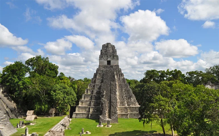 visiting Guatemala pyramid with trees on a sunny day