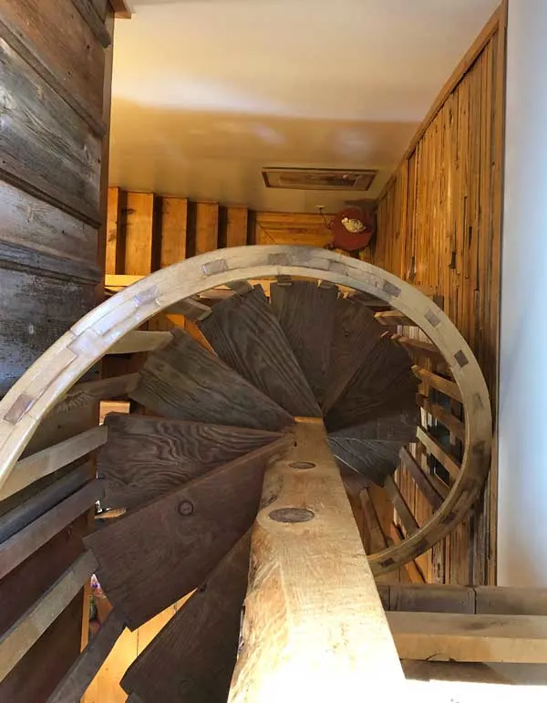 this B&B has a circular stairway going up to the top deck