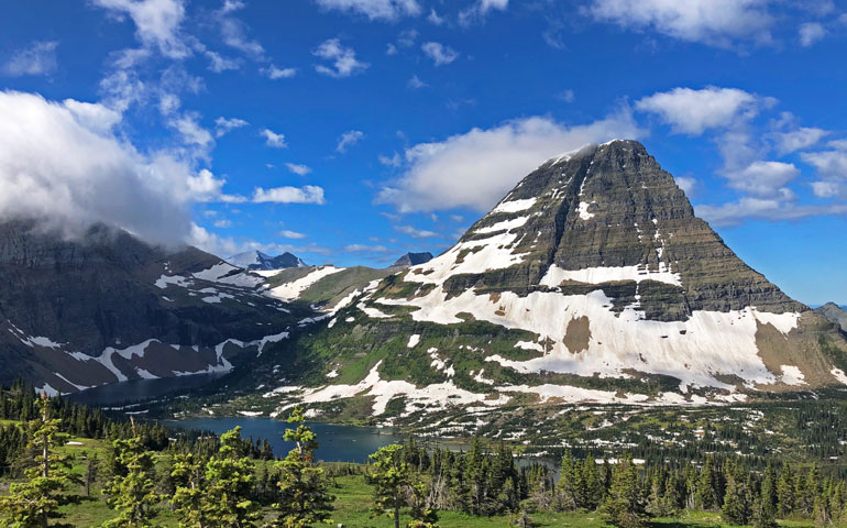 national park guides photo of mountain cliff with snow and lake blue sky