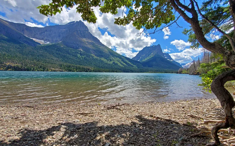 view from the lake with mountains in the distance