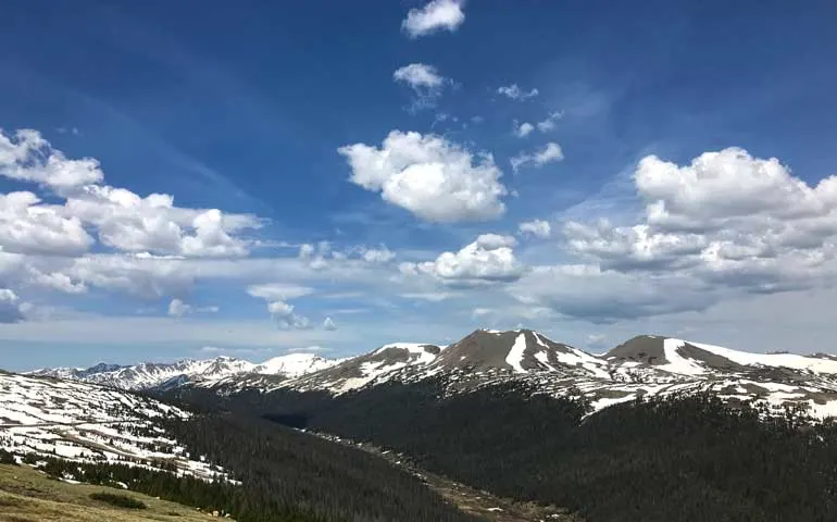 visiting Colorado: Rocky Mountains white capped mountains on blue sky day