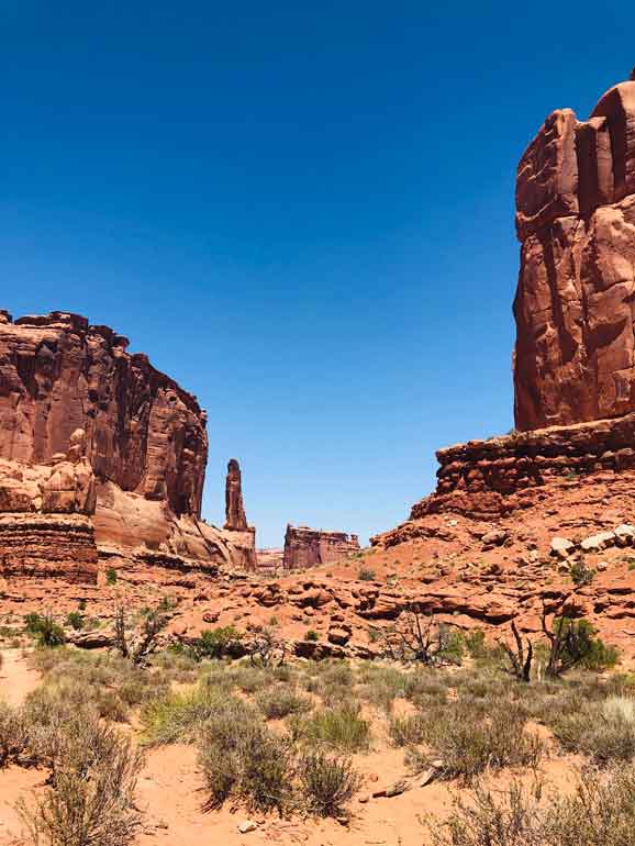 best national parks to visit in April picture of towers of stone red dirt desert scene