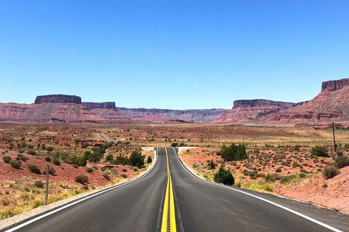 best road trips picture of road through the desert on a sunny day