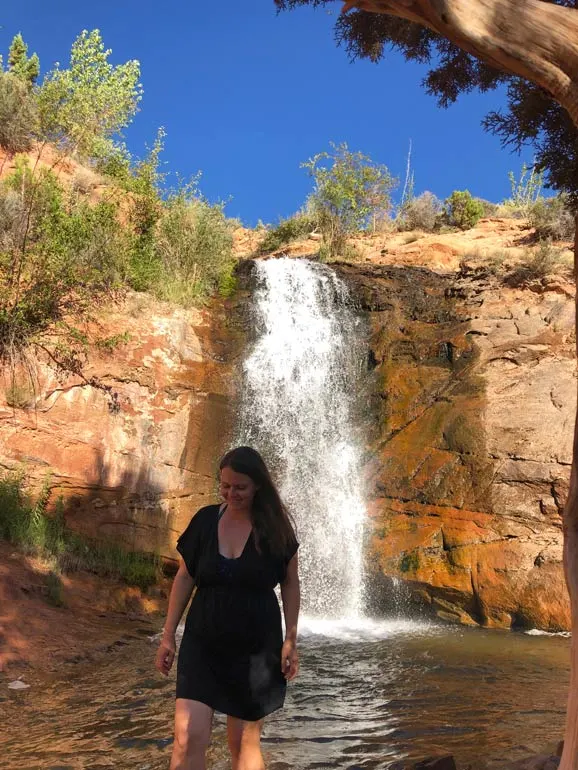 Faux Falls Utah woman standing at waterfall