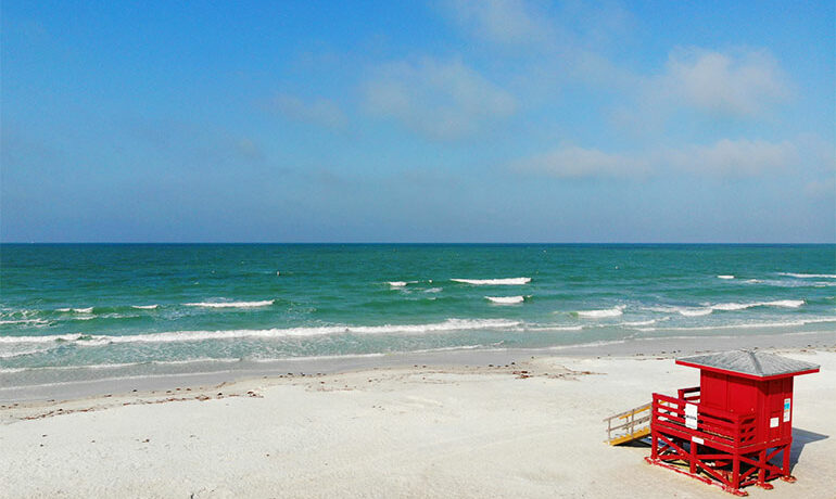 picture of the best beaches in florida for families - siesta key beach white sand teal water red guard station