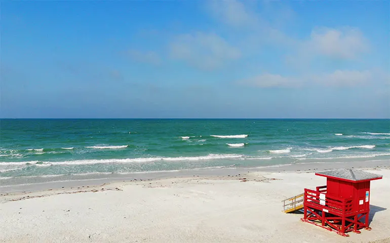 picture of the best beaches in florida for families - siesta key beach white sand teal water red guard station