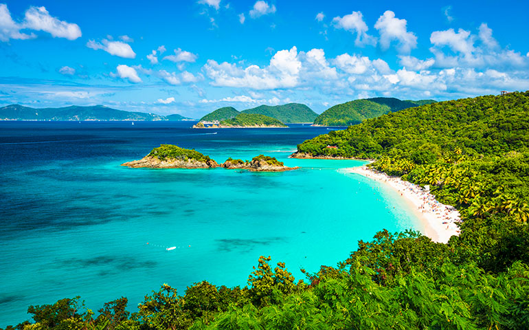 warm winter vacations picture of caribbean water with beach and hillside