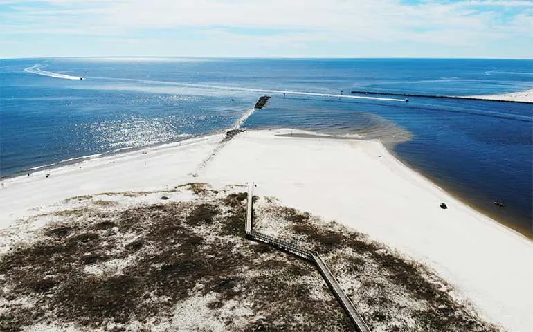 aerial view of alabama point with white sand and ocean in background