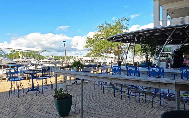 boat bar and marina with chairs on a sunny day