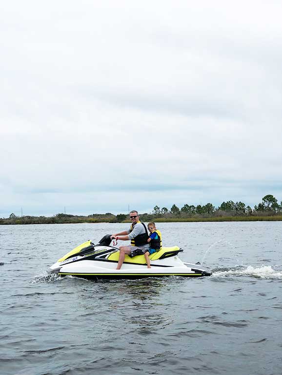 jet ski rental orange beach father and son ride on the water