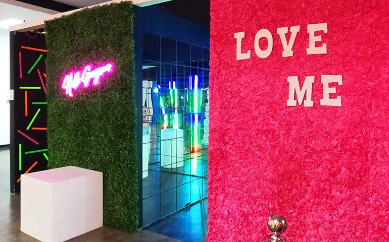 selfie museum with signs that say hello gorgeous and love me