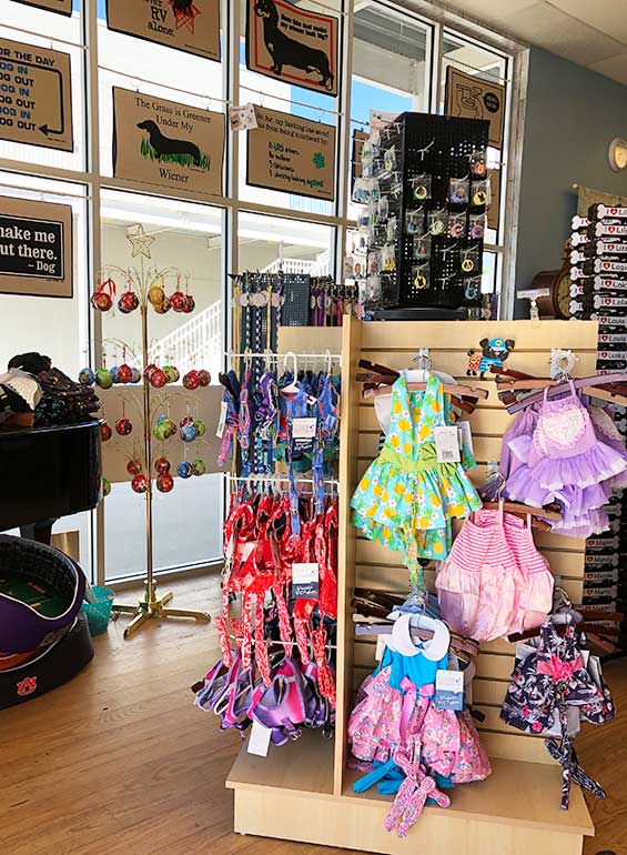 pet supplies store with pet outfits, collars and door mats