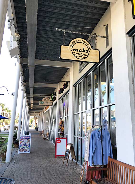 line of storefronts at the wharf at orange beach including covered sidewalk