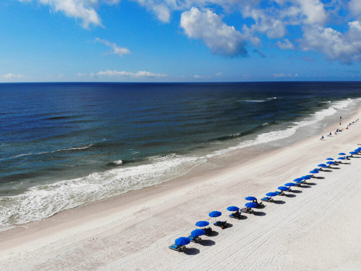 orange beach AL white sand blue water umbrellas