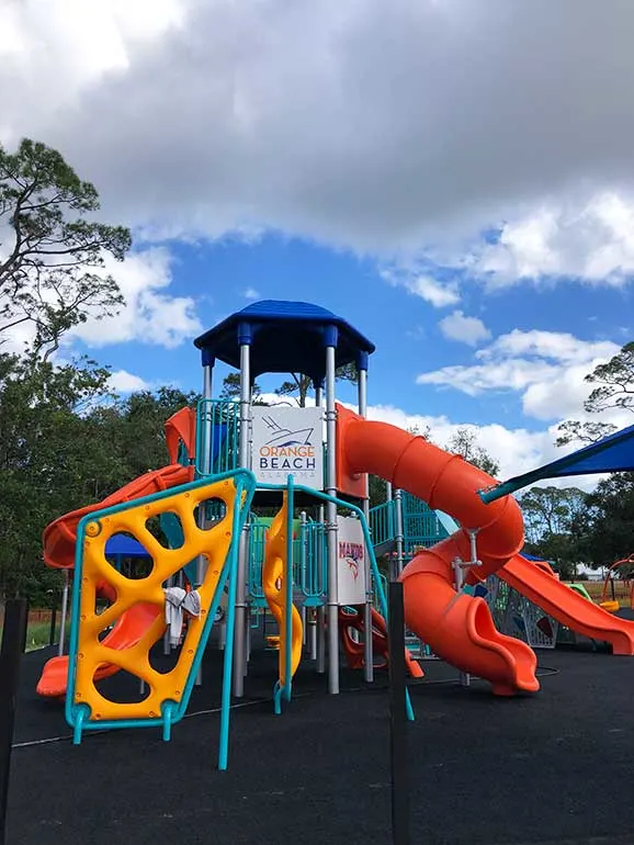 playground in orange beach with colorful equipment including slides