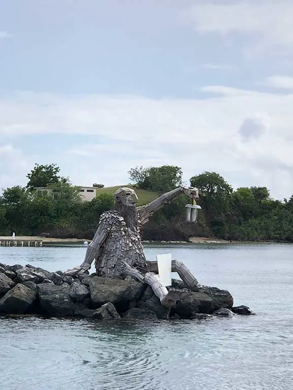 giant wooden troll in culebra Puerto Rico with water