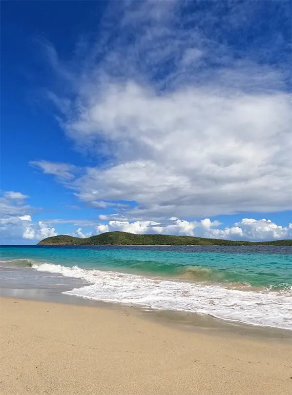 beach in culebra Puerto Rico with white sand, teal water, island in distance