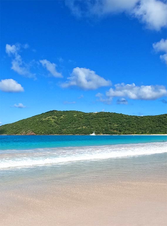 beautiful beach in culebra Puerto Rico white sand teal water island in distance blue sky