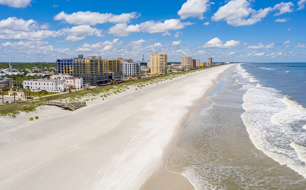family friendly beaches in florida Jacksonville Beach aerial shot white sand city in background