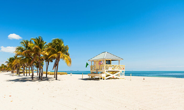best beaches in Florida for families, white sand palm trees lifeguard station