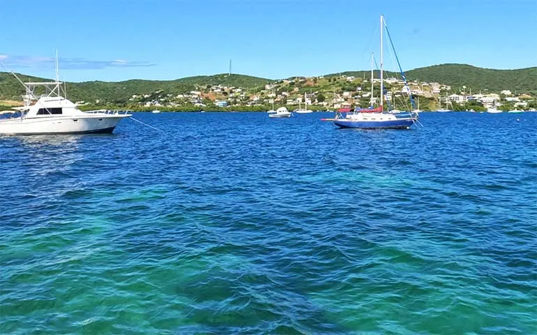 blue waters of culebra Puerto Rico bay with boats and hillside