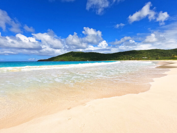 flamenco beach Puerto Rico white sand blue water and picturesque hills on a sunny day