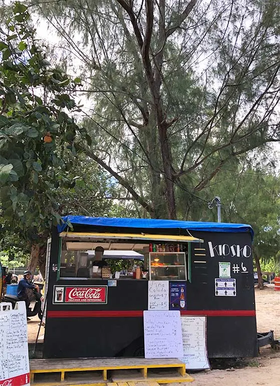 what to eat at flamenco beach pic of little food trailer with menu and coca cola sign