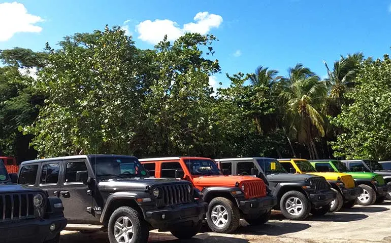 multi colored jeeps in a line at flamenco beach, culebra Puerto Rico 