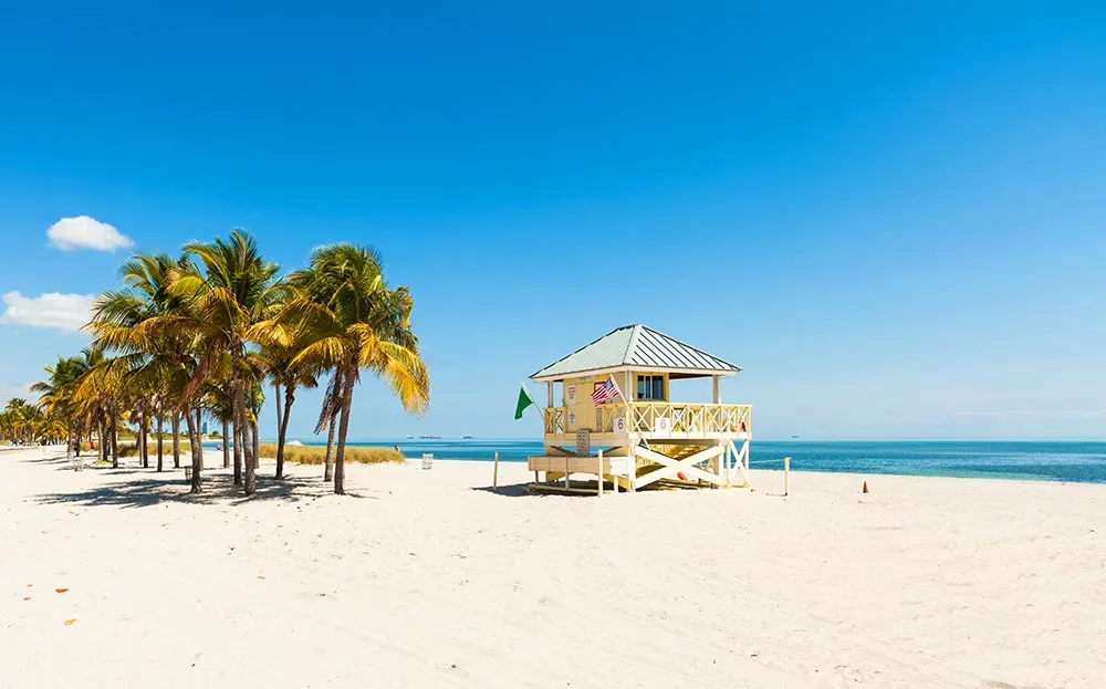 best beaches in florida for families white sand beach lifeguard post palm trees