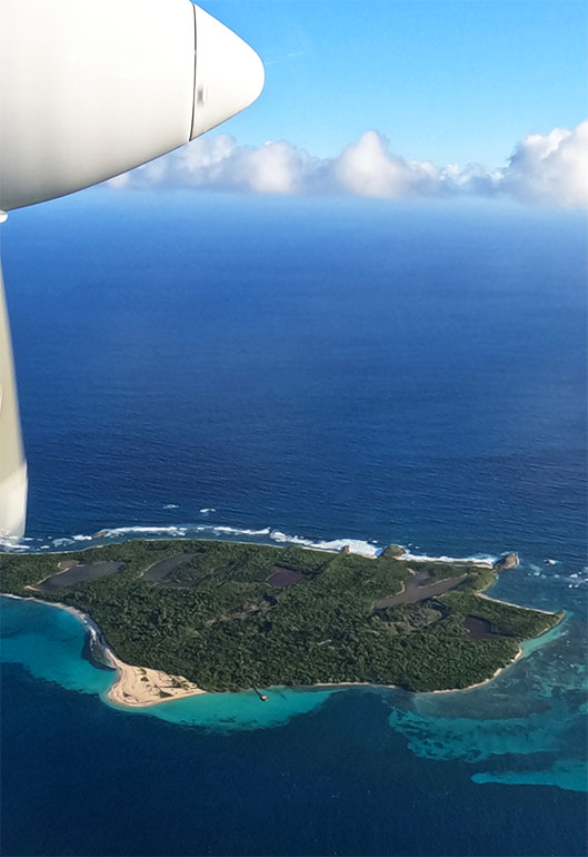 small island in caribbean as seen from airplane window