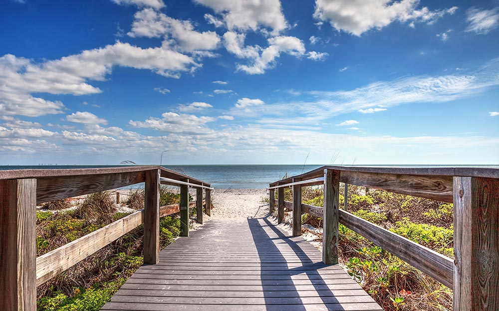 boardwalk to beach on sunny day best family vacation spots in florida