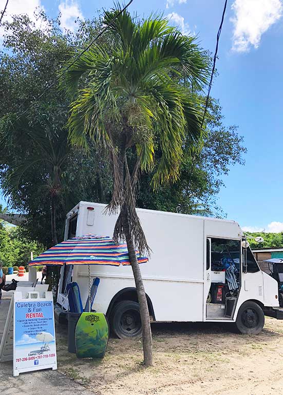 rentals at flamenco beach photo of truck, palm tree umbrellas