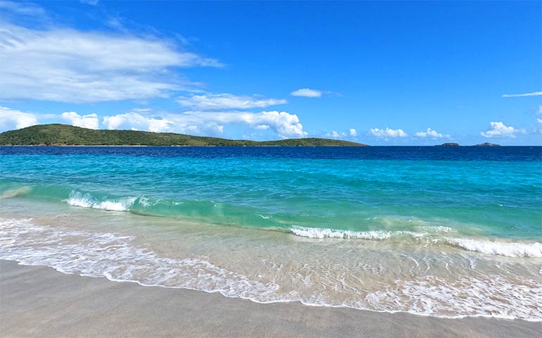 beaches in culebra Puerto Rico with teal water island in background sunny sky