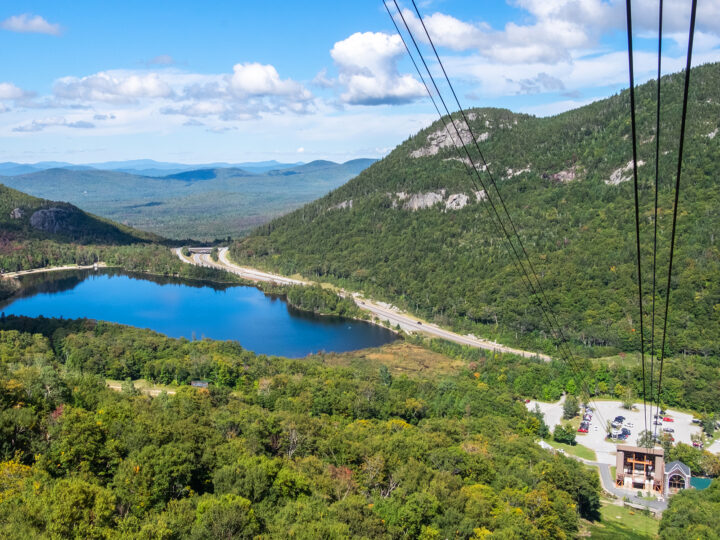 view of mountains from ski lift on sunny day with lake and trees in New Hampshire best honeymoon destinations usa