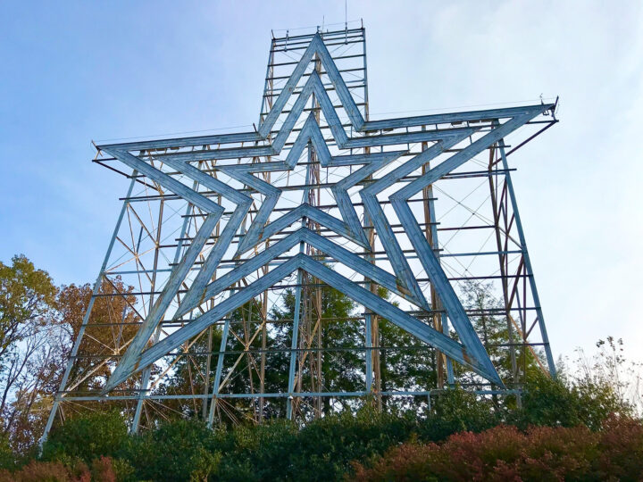 large metal star on stand in field