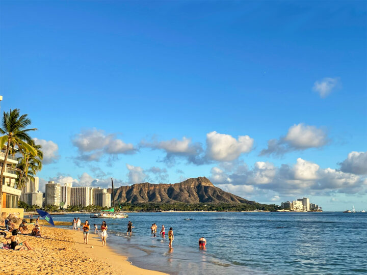 beach honeymoon destinations usa Waikiki beach with hotels and palm trees overlooking diamond head