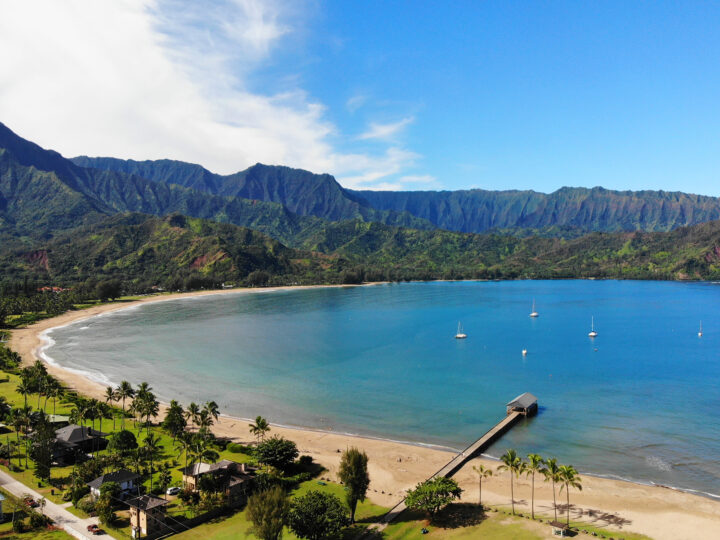 best honeymoon destinations USA-Hanalei bay photo of blue water in bay with mountain background and pier