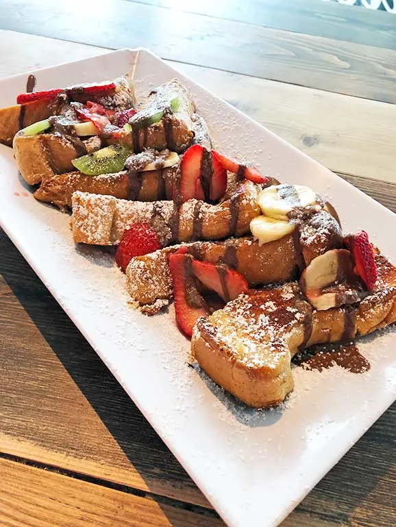 French toast drizzled in Nutella with fresh fruit