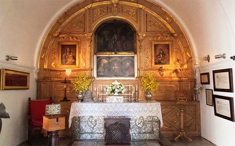 golden altar in rounded top building with oil paintings at Capilla del Cristo, one of the top things to do in old San Juan