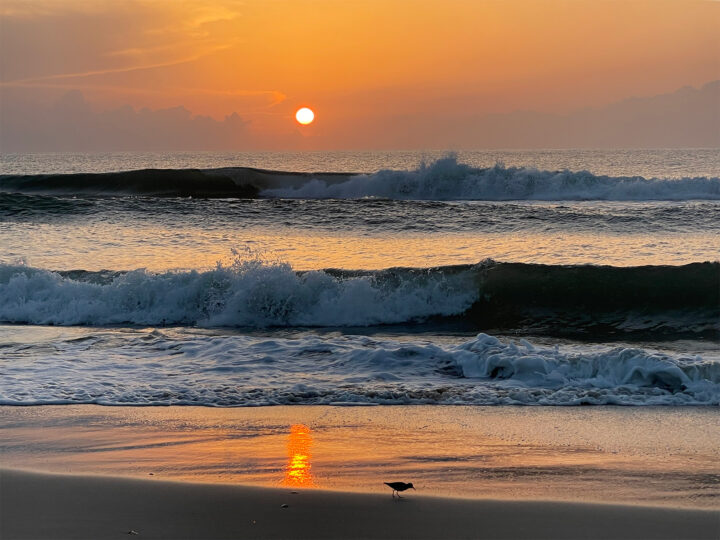 outer banks North Carolina sunset with waves and orange sky